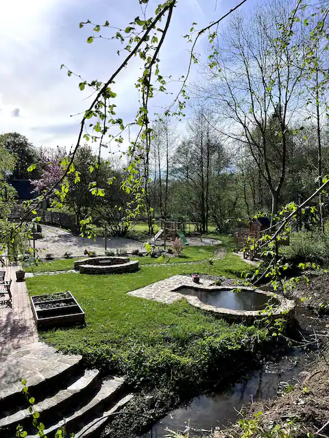 Stream winding around the garden beside the stone steps